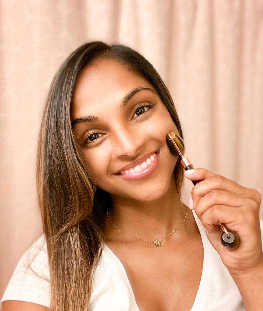 Anjali uses a Whimsy + Wellness gemstone facial roller as part of her skincare routine