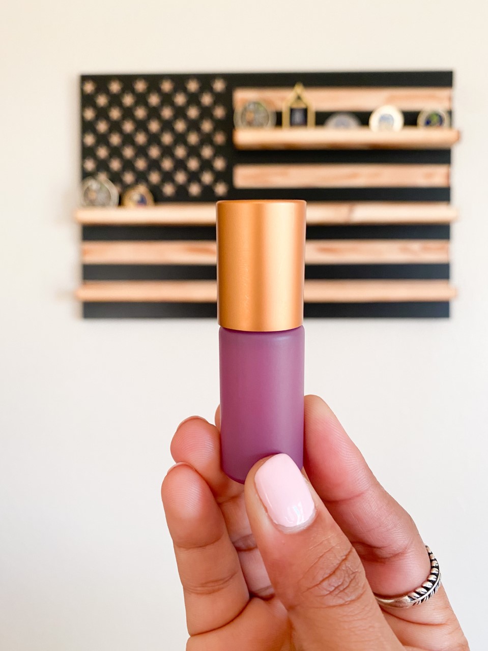 Anjali holds a purple 5ml roller bottle from the Whimsy + Wellness Bohemian Collection