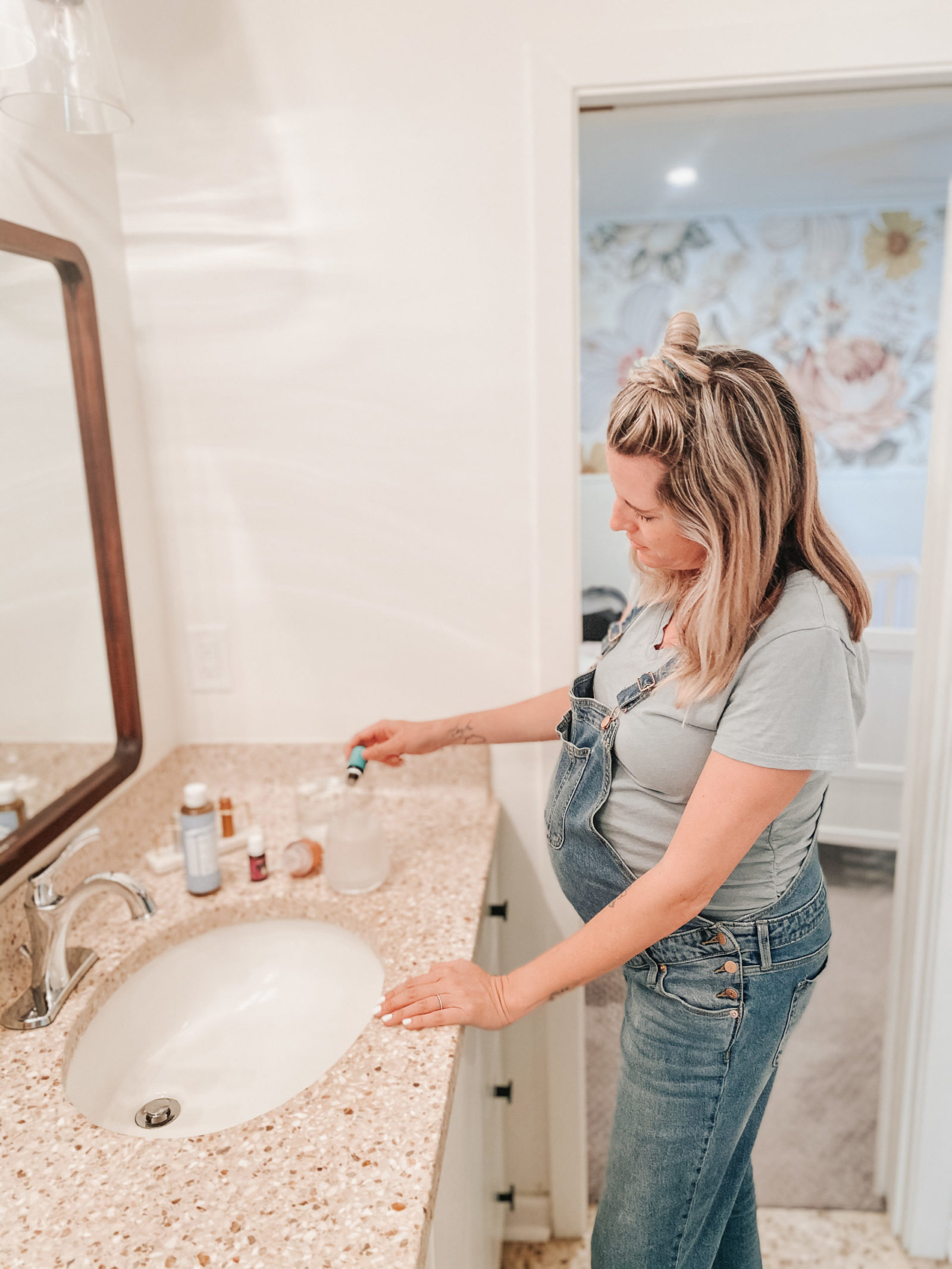 Wynne Elder fills a Whimsy + Wellness foaming hand soap dispenser with Young Living Essential oils.