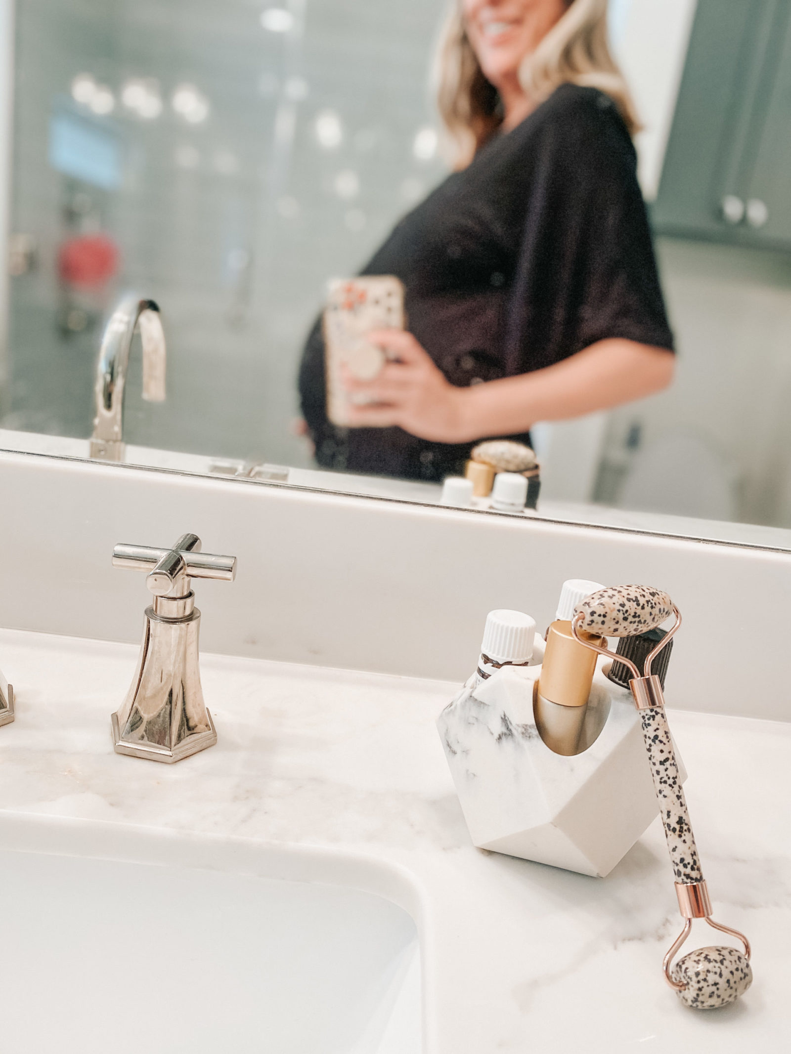 Wynne Elder uses a Whimsy + Wellness gemstone facial roller with Young Living Essential oils for skin support during pregnancy.